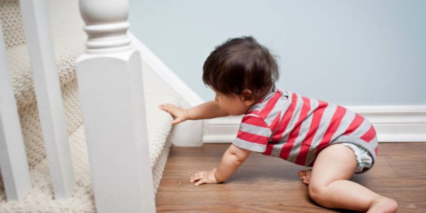 Toddler starting to climb the stairs