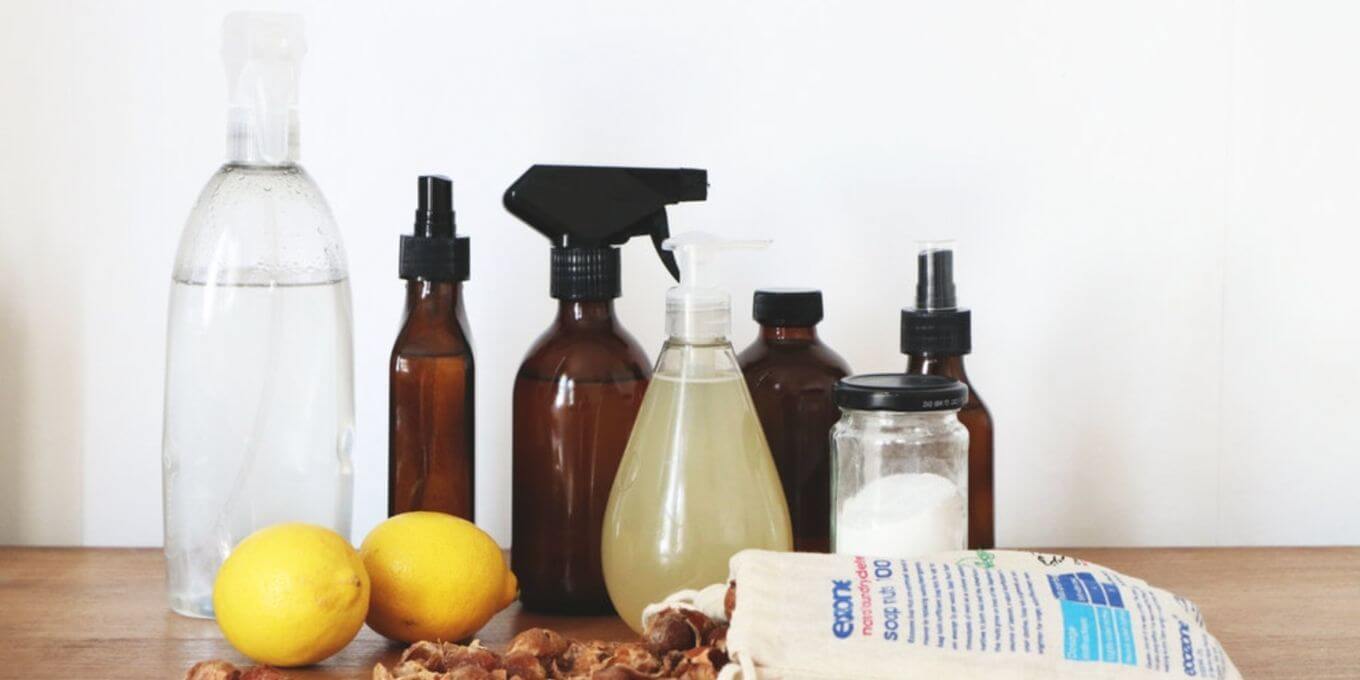 Natural cleaning products and lemons lined up on a counter