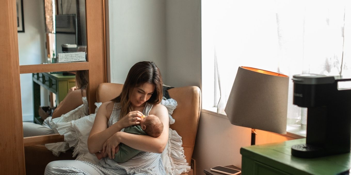 Mother holding her baby in a nursery