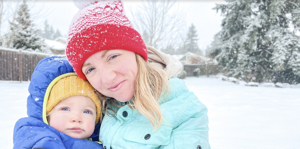 Mom and child smiling in the snow