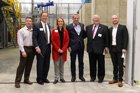 The CON-CRET team standing together at the grand opening of their new manufacturing plant.