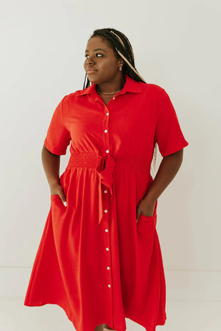 bright red mid-length dress with buttons down the front and bow tie waistline. www.loveoliveco.com