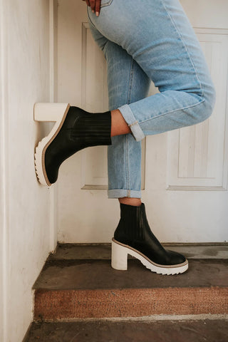 black boots with an off-white sole and heel. www.loveoliveco.com
