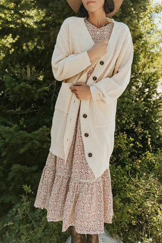 knitted cream knee-length cardigan to wear this fall. www.loveoliveco.com