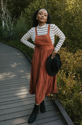 cute overall dress in a rust color. www.loveoliveco.com