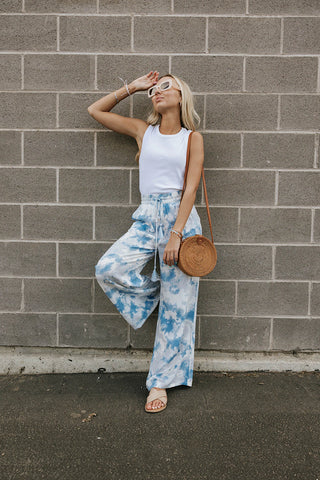 tie-dye white and blue flare pants with a white tank top. www.loveoliveco.com
