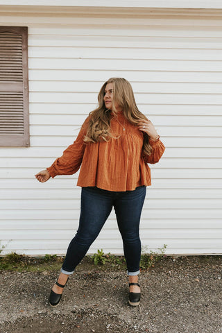 long sleeved orange textured blouse. www.loveoliveco.com