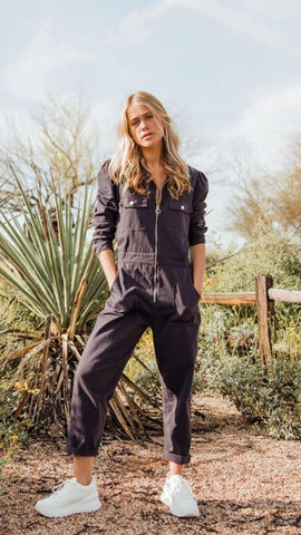 black jumpsuit with zippers and buttons. www.loveoliveco.com