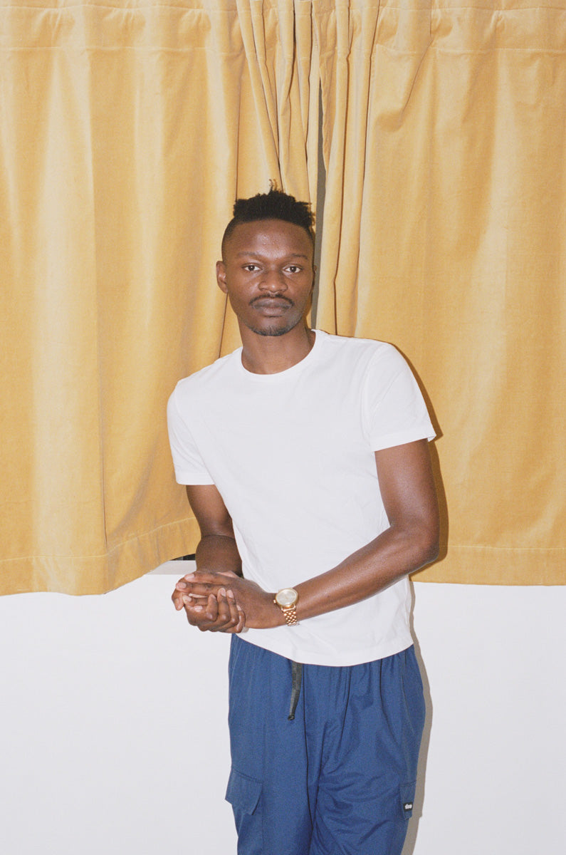 Theo Martins standing in front of curtain