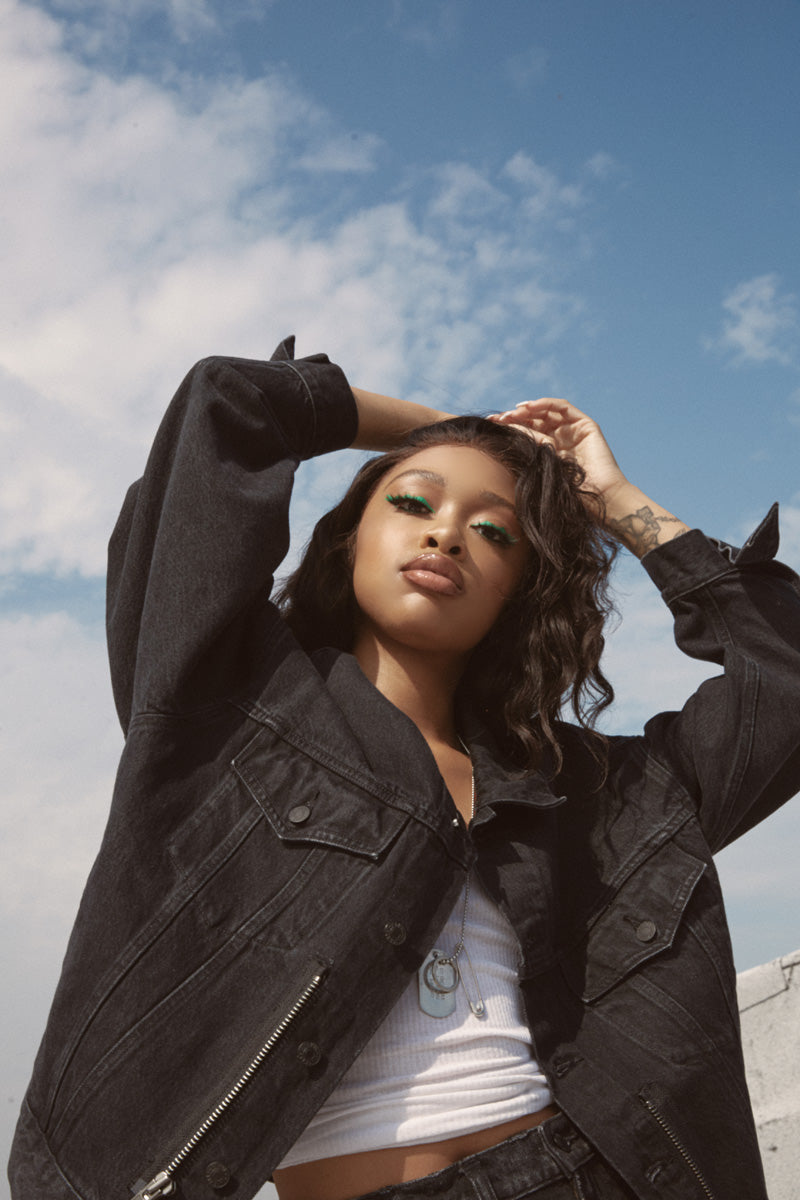 Close up of Andrea with cloudy sky above and behind her