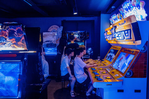 people playing video games in an arcade