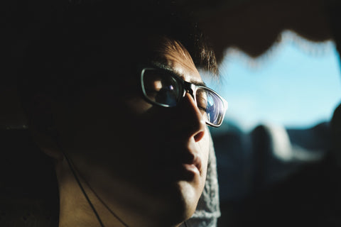 close up of Asian man with glasses taking a nap