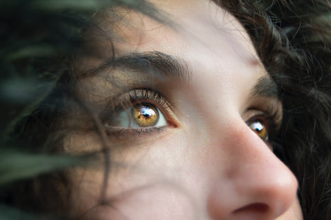 close up of woman with beautiful hazel colored eyes