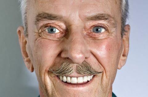 close of up of old man with healthy eyes and bright smile
