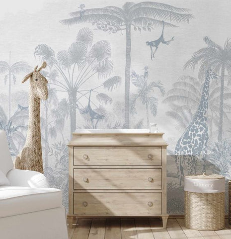 baby nursery with blue wallpaper and light timber chest of drawers