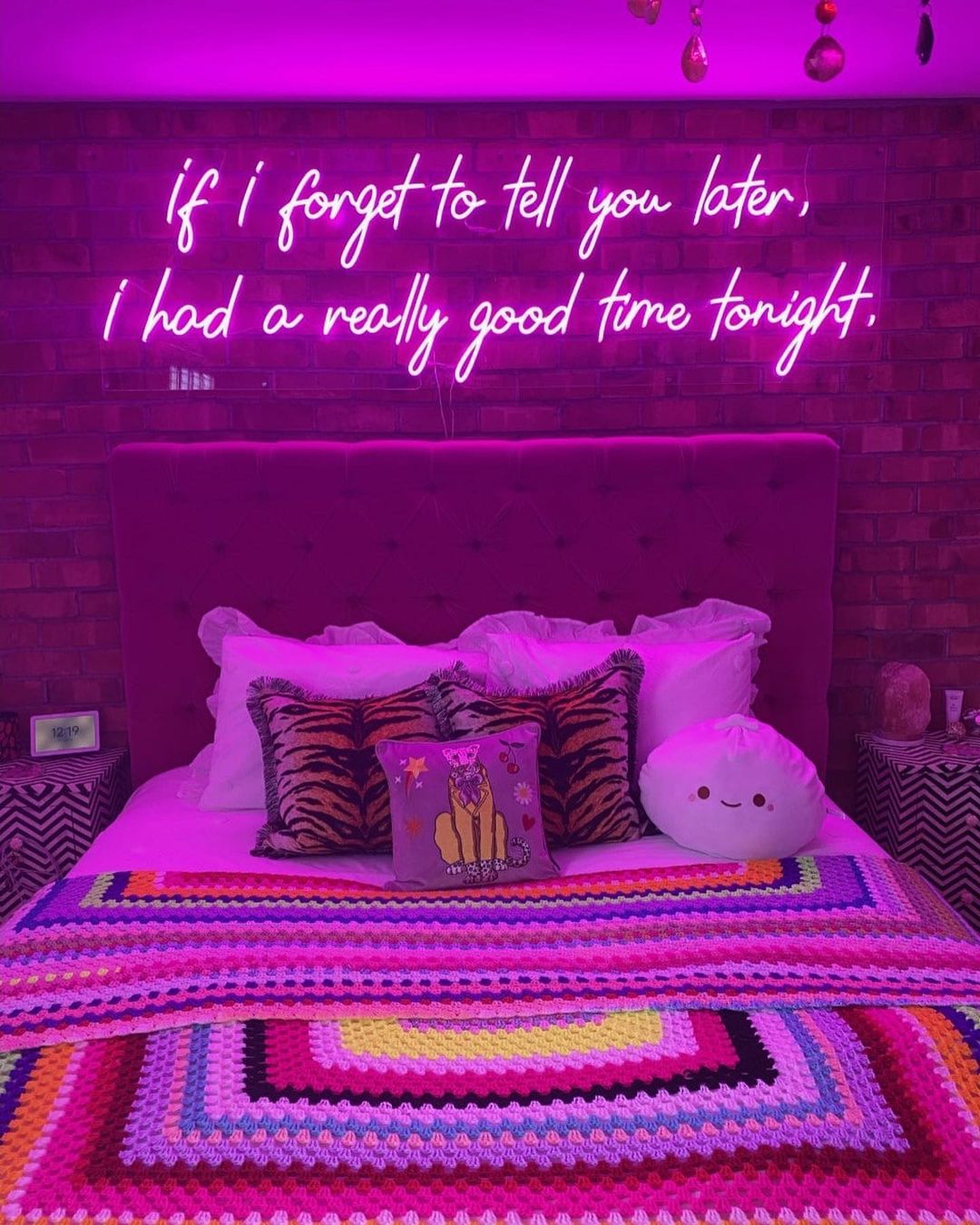 bedroom with neon sign