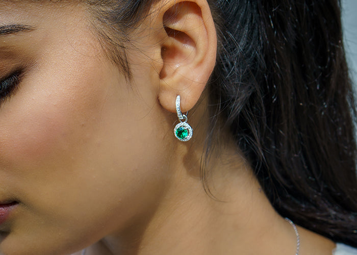 Woman wearing emerald earring