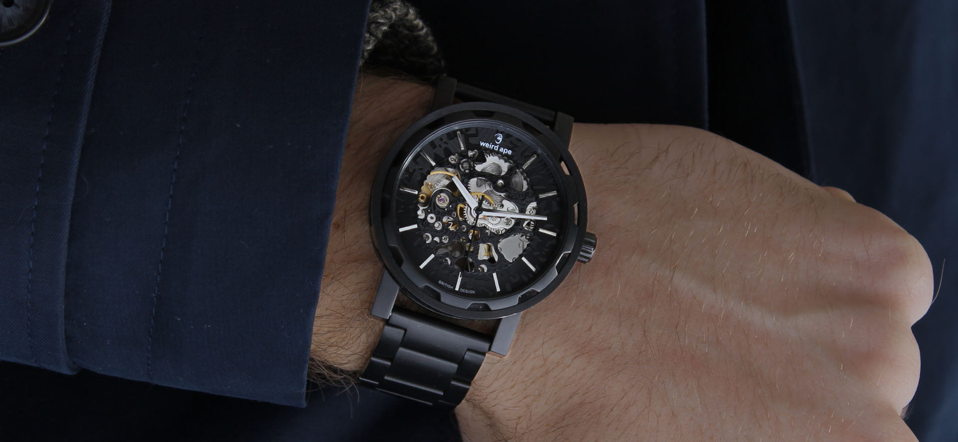 Black skeleton watch with a black strap in a lifestyle image