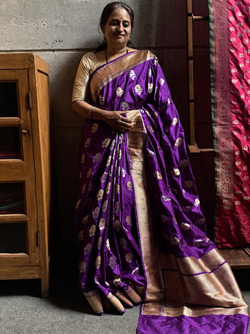 Royally elegant!  A bright and beautiful purple banarasi katan silk handwoven saree with kadhwa meenakari sona rupa  buttas in tested zari. The colour and the design is just right to make you stand out.   This beauty is woven in 17-18 days.   This sari is available only on pre-order and takes 45-60 dys to deliver. 