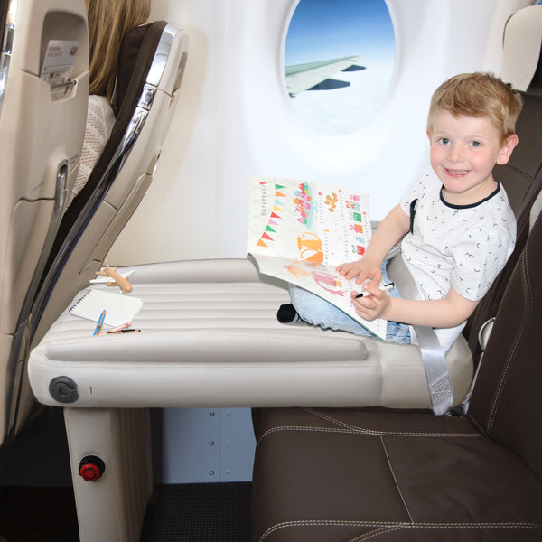 Flyaway Kids Bed child reading book on plane