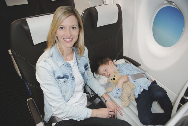 child sleeping on the plane with Flyaway Kids Bed