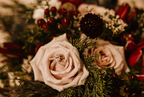 Oval Center vintage millgrain engagement ring pictured in a bouquet of warm colored flowers