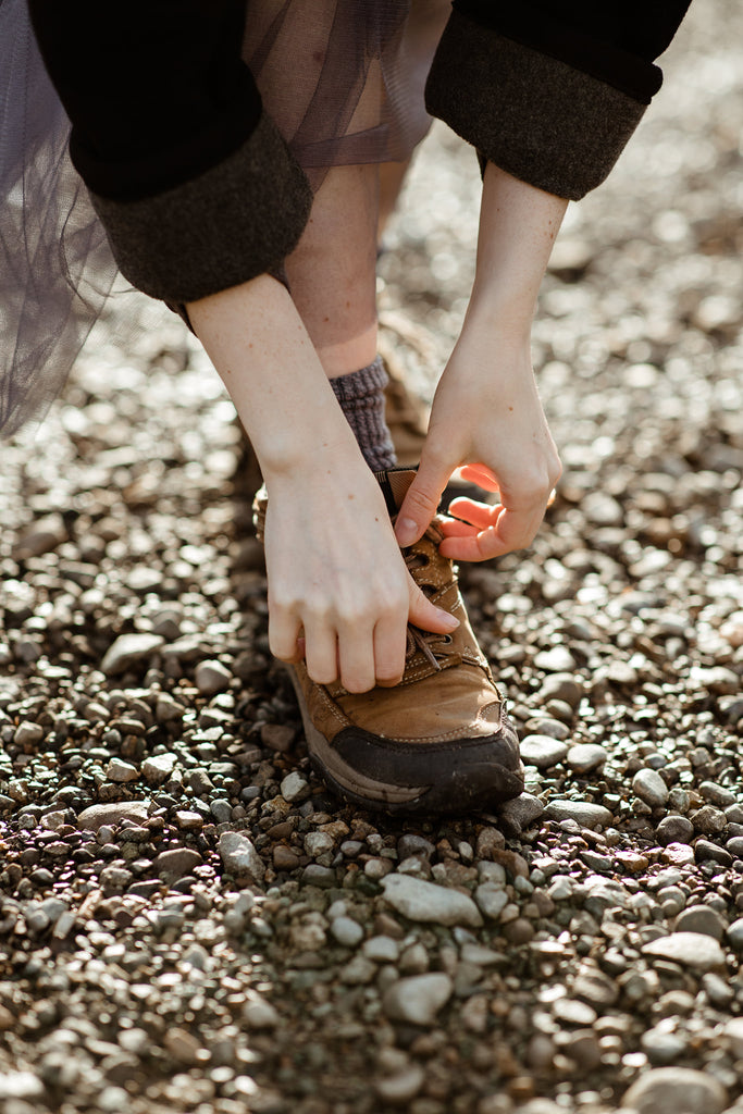 close up of a woman tying her shoelaces where chromatic aberration effect is apparent