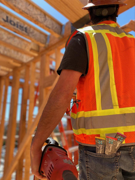 can dehydration cause vertigo: construction man with DripDrop ORS in his back pocket
