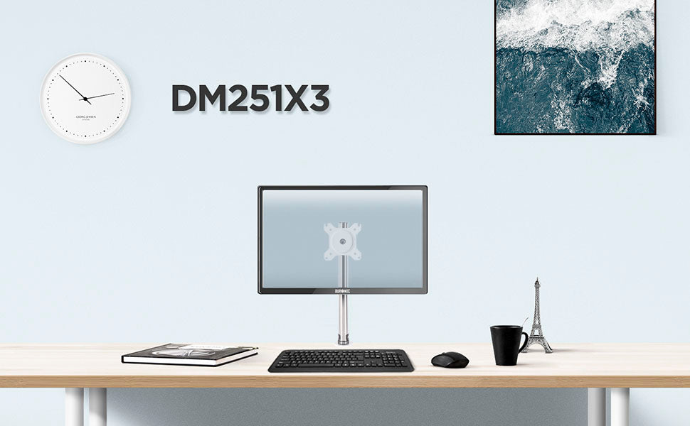 DM251X3 monitor stand on desk top surface, surrounded by office accessories. 
