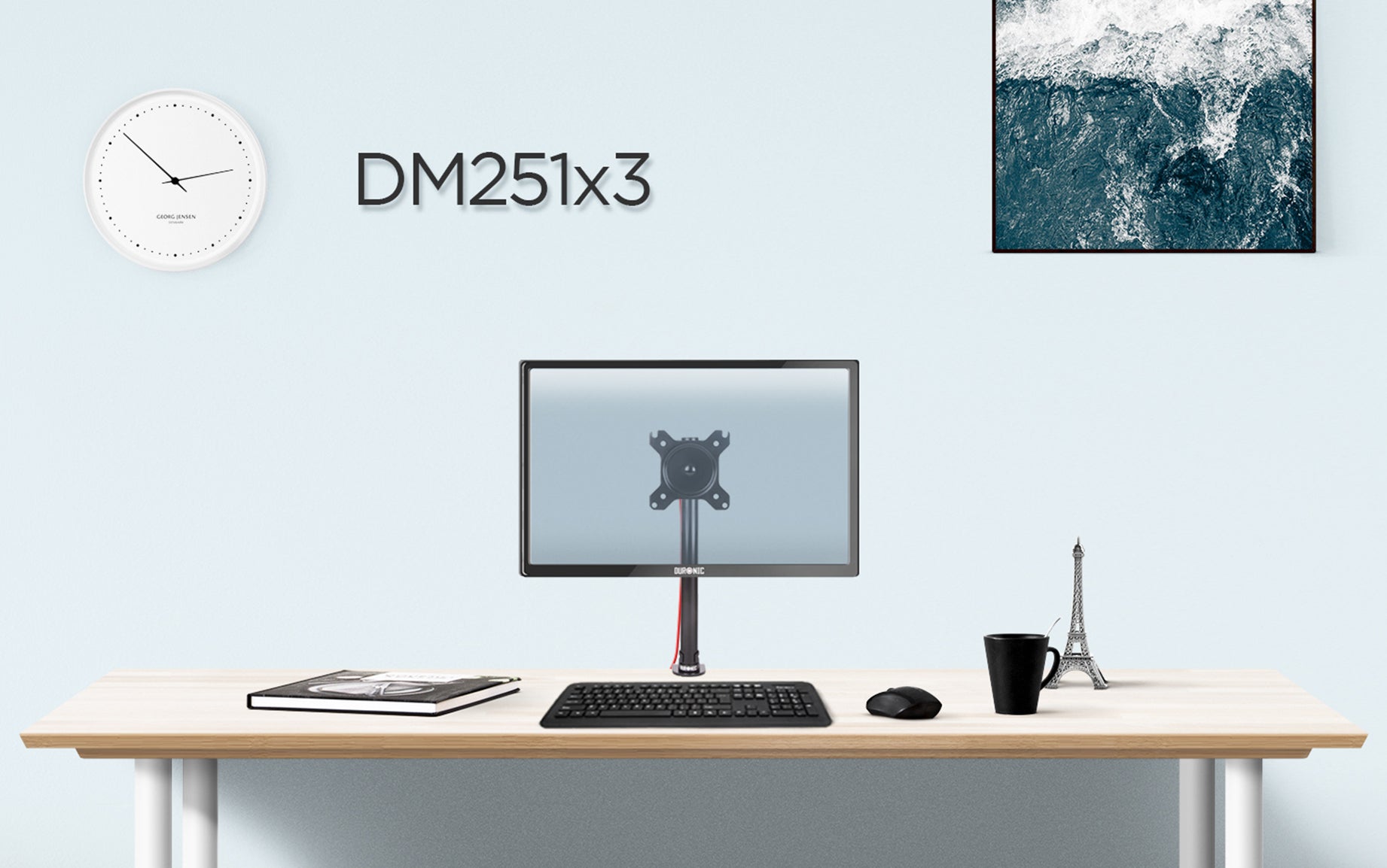 DM251X3 monitor stand on desk top surface, surrounded by office accessories. 