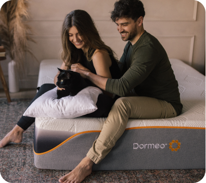 Couple with Black Cat Sitting on Dormeo Mattress
