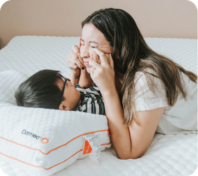 Woman Playing with Child on Dormeo Bed and Pillow