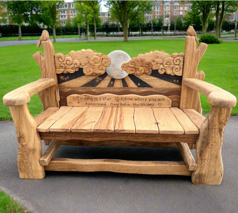 Side angle of a rustic wooden bench showcasing the natural wood grain, carved decorative elements, and an engraved tribute message. The bench's sturdy design and artistic features make it a unique outdoor piece