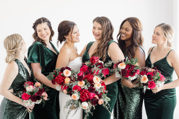 Stunning jewel-toned florals and evergreen bridesmaids dresses in Fargo, ND, set the tone for a playful and colorful winter wedding