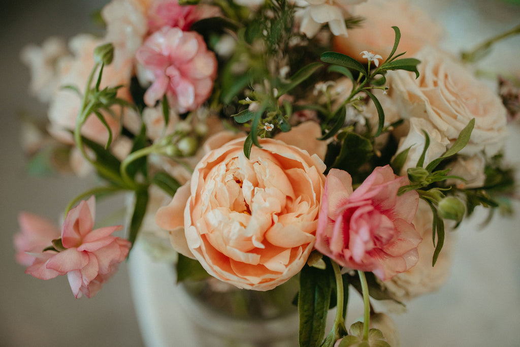 Discover the Perfect Cozy and Relaxed Spring Wedding Vibe with a Cocktail Camper Shoot in Fargo, ND - Surrounded by Peach Peonies, Blush Butterfly Ranunculus, and Light Peach Roses