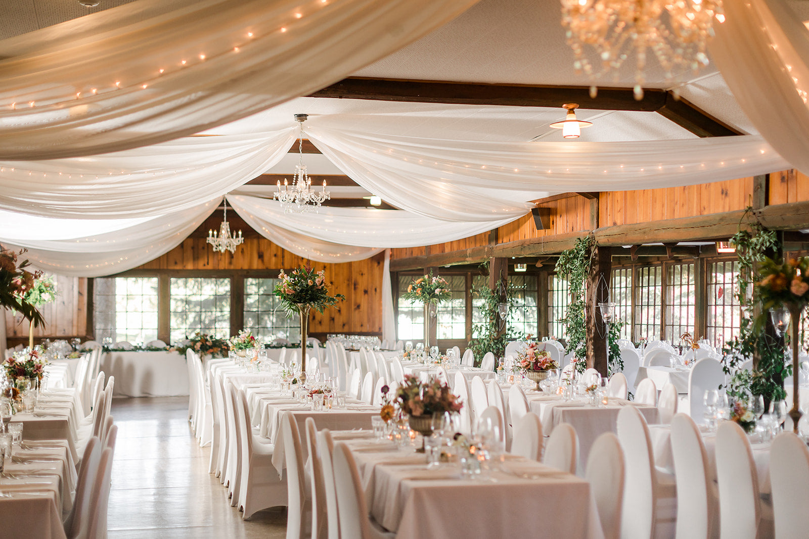 Picture Perfect Fall Wedding Flowers: Rich Tones and Elegant Arrangements  This stunning fall wedding at Fair Hills Resort was made even more beautiful with the addition of fall-colored florals by Floret and Foliage. The bride carried a bouquet of tulips, roses, and stock in warm, autumn tones, adding a touch of sophistication to the laid-back atmosphere. The reception was adorned with elegant floral arrangements, enhancing the natural beauty of the lake setting. Whether you're planning a cozy, intimate wedding or a grand celebration, let Floret and Foliage bring your vision to life with their picture-perfect florals. Book now for a fall wedding that will take your breath away. Fair Hills Resort Wedding reception flowers Two Birds Photography