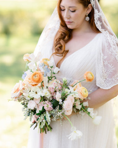 Peaches and whites flower bouquets, stunning bridal flowers and bride at Meadows on Lind in Detroit Lakes, Minnesota