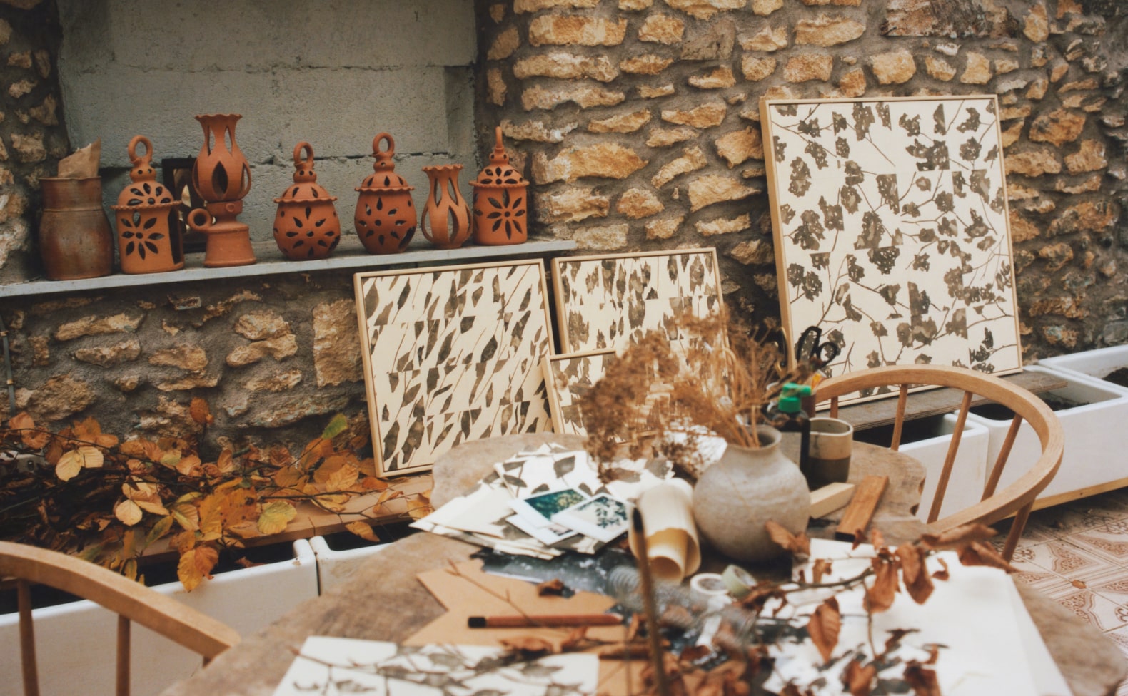 Outdoor workshop with pots and paintings