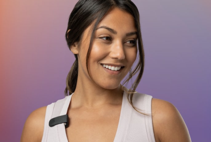 Woman wearing her Apollo on shirt strap using Apollo Clip