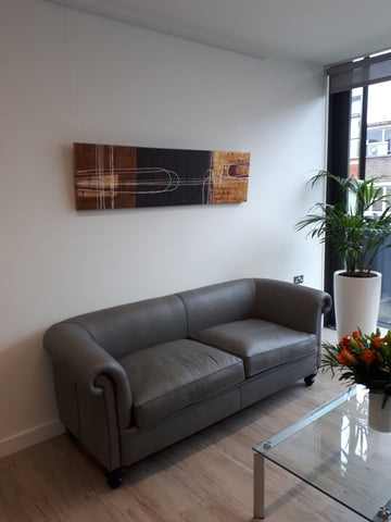long original abstract painting above sofa in reception area of office 