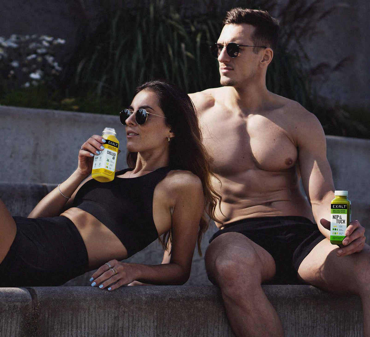 two people enjoying EXALT juices wearing activewear