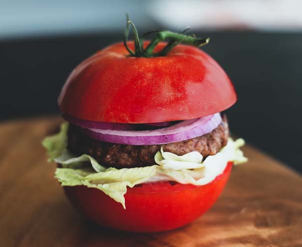 a burger with a tomato bun