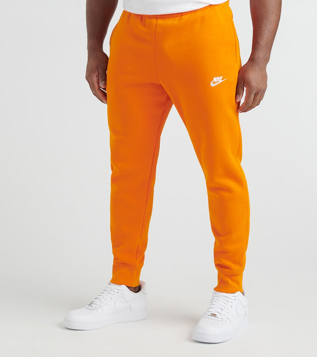 orange and black nike jogging suit