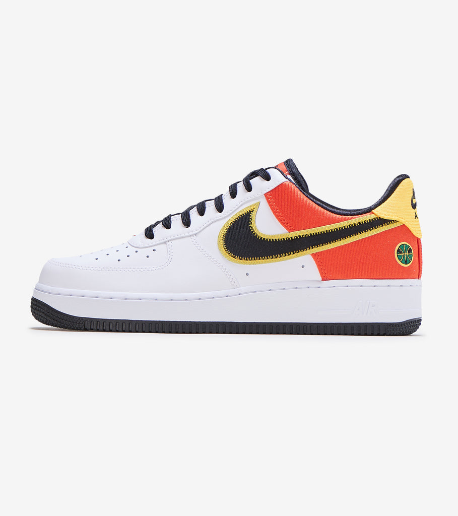 white and black air forces with orange lettering