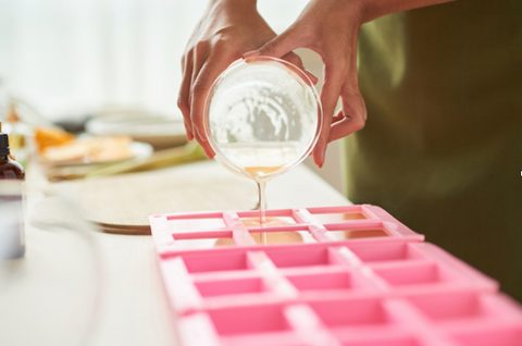 pouring melt and pour soap into silicone molds