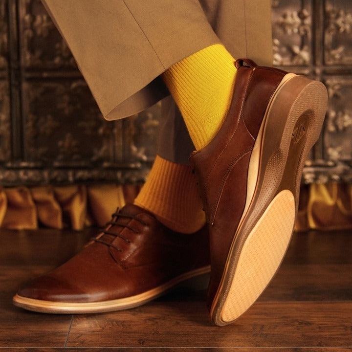 Man wearing chestnut shoes with yellow socks