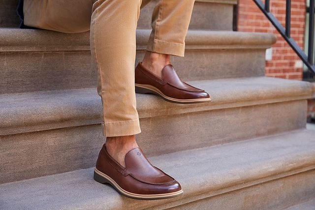 Man wearing brown leather loafers on outdoor steps