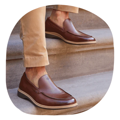 A man in his Chestnut men’s slip-on dress shoes on a set of stairs