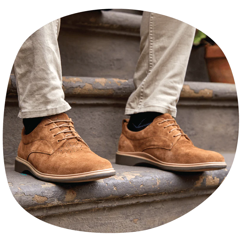 Person sitting on steps, wearing The Original in Grizzly Brown Suede from Amberjack