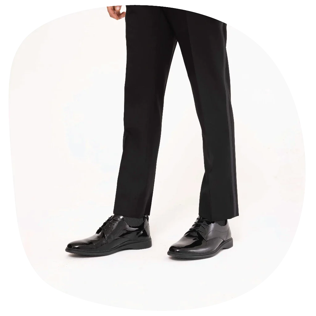 A man wearing shiny black tuxedo shoes